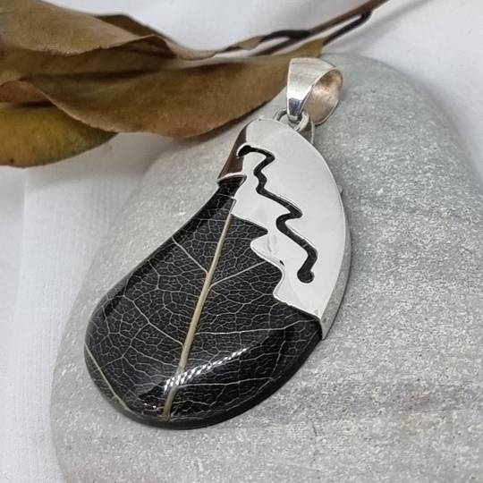 Black skeleton leaf pendant with silver detailing