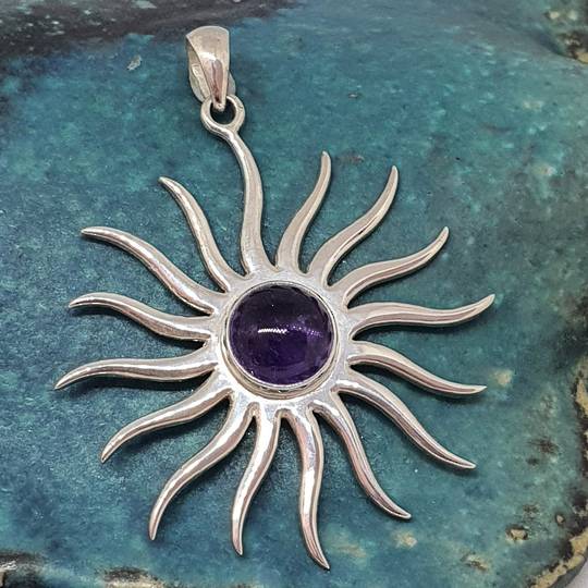 Large silver star pendant with glowing amethyst