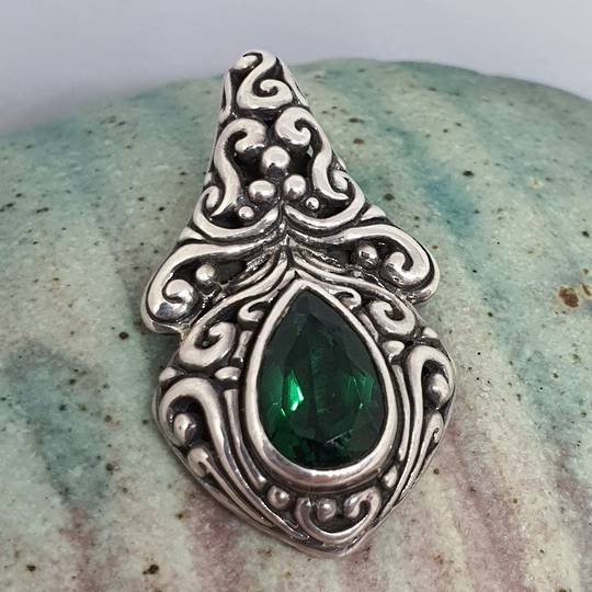 Green quartz pendant set in heavy decorated silver