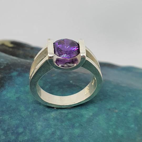 Open sides, sterling silver ring with purple stone