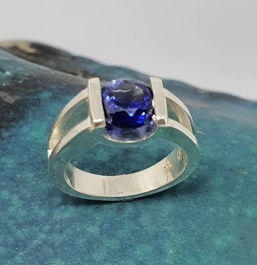 Open sides, sterling silver ring with deep blue gemstone