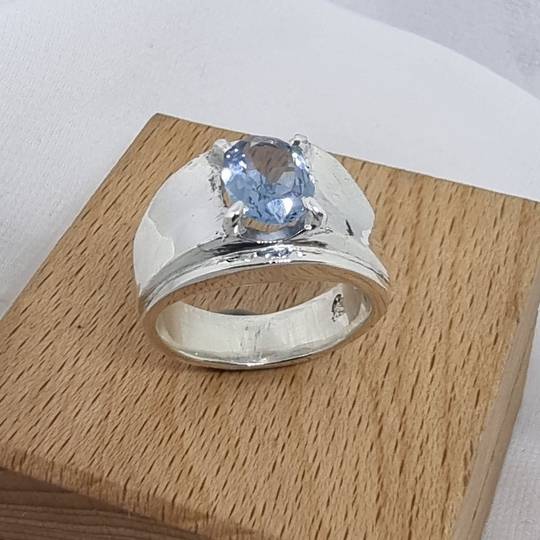 Wide silver band ring with blue topaz simulated gemstone
