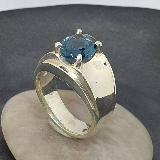 Wide silver band ring with blue topaz simulated gemstone
