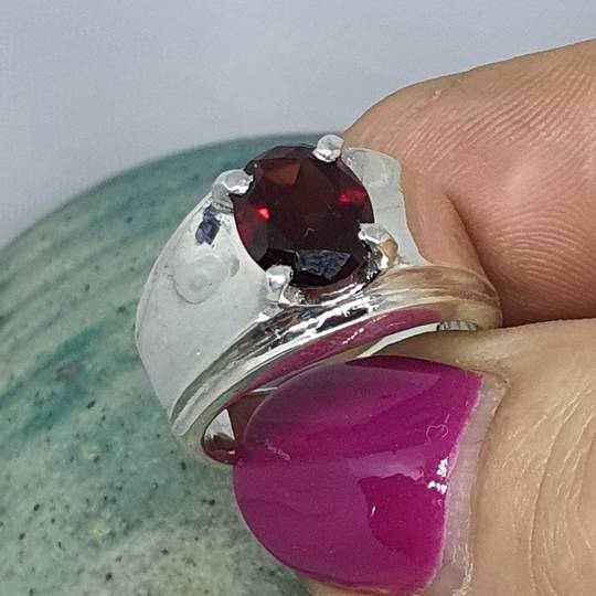 Wide silver band ring with red garnet gemstone