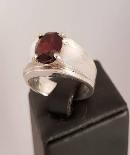 Wide silver band ring with red garnet gemstone
