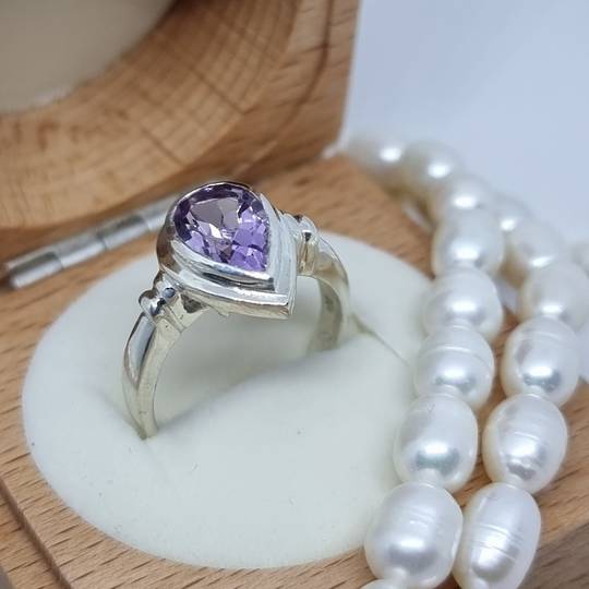 Silver ring with sparkling purple gemstone
