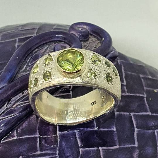 Made in NZ. brushed silver ring with natural peridot