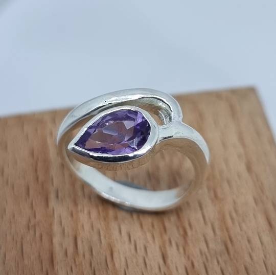 Silver ring with sparkling purple gemstone