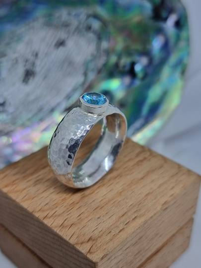 Sterling silver hammered band with blue topaz