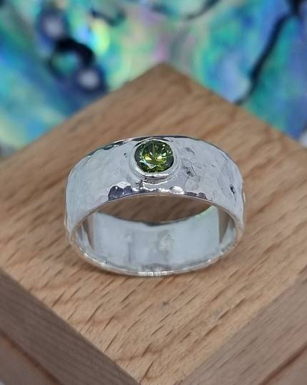Sterling silver hammered band with green gemstone