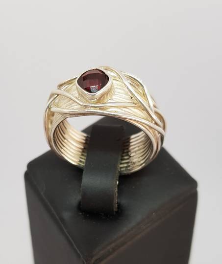 Wide silver band with sparkling garnet set in the top