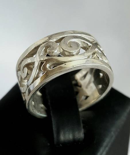 Sterling silver wide band with carved koru designs