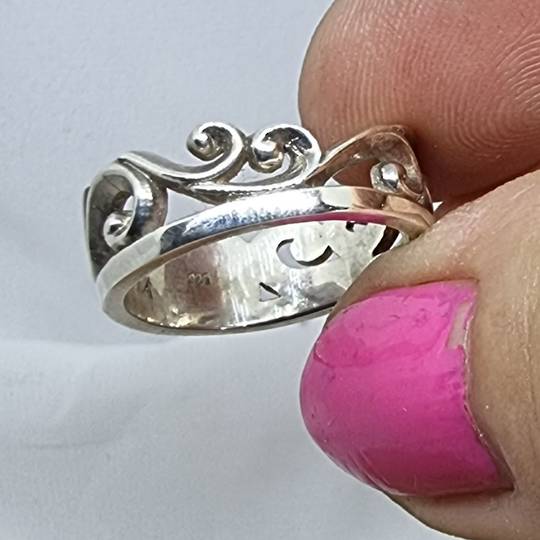 Sterling silver ring with koru details in band