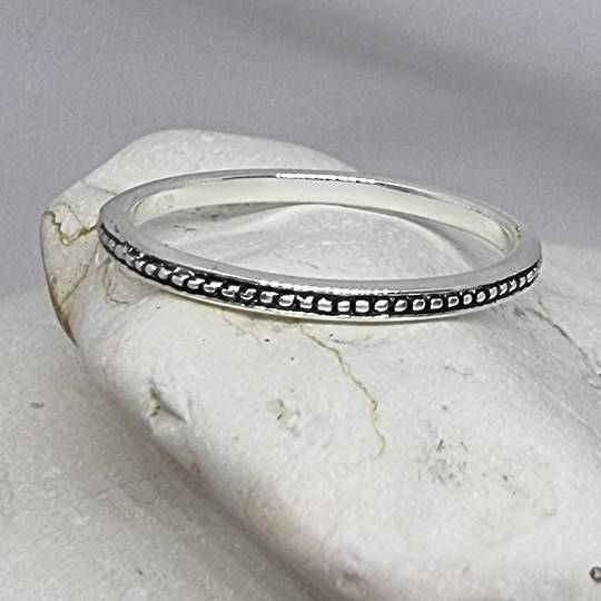 Sterling silver stacking ring with dotted detailed band