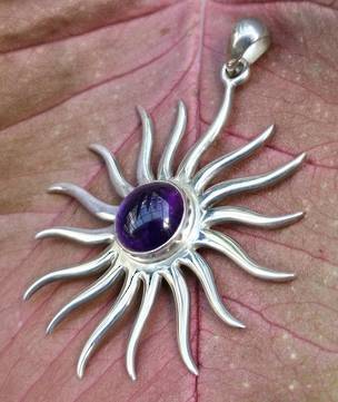 Large silver star pendant with glowing amethyst